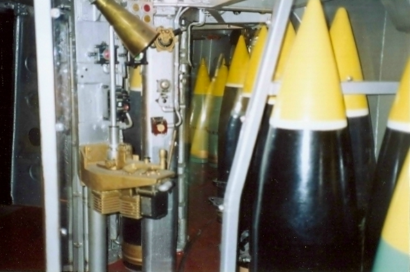 Handle on the gold colored plate controls forward and backward rotation of the projectile ring.