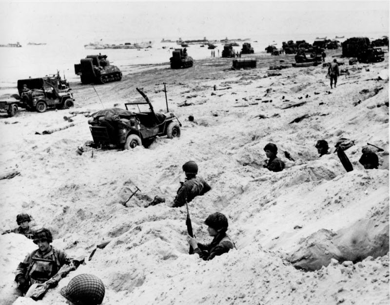 American soldiers in foxholes secure beachhead at Normandy