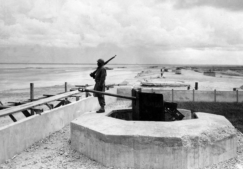 Lone US soldier guards knocked-out German gun position at Utah Beach