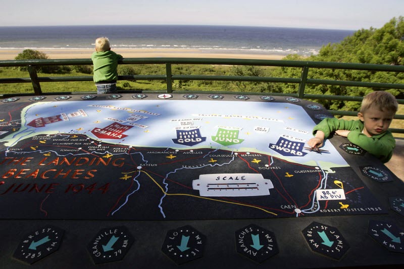 Child plays with map of landing beaches at American Cemetery 2009