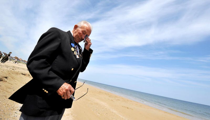British Royal Navy veteran Harry Buckley wipes tears at Normandy 2009