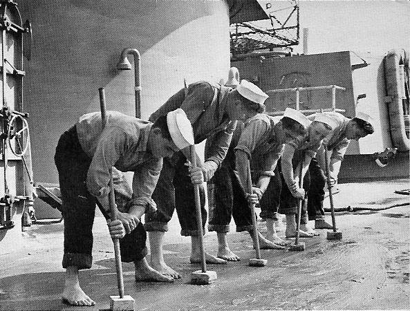 Sailors holystoning the teak deck of USS Missouri BB-63